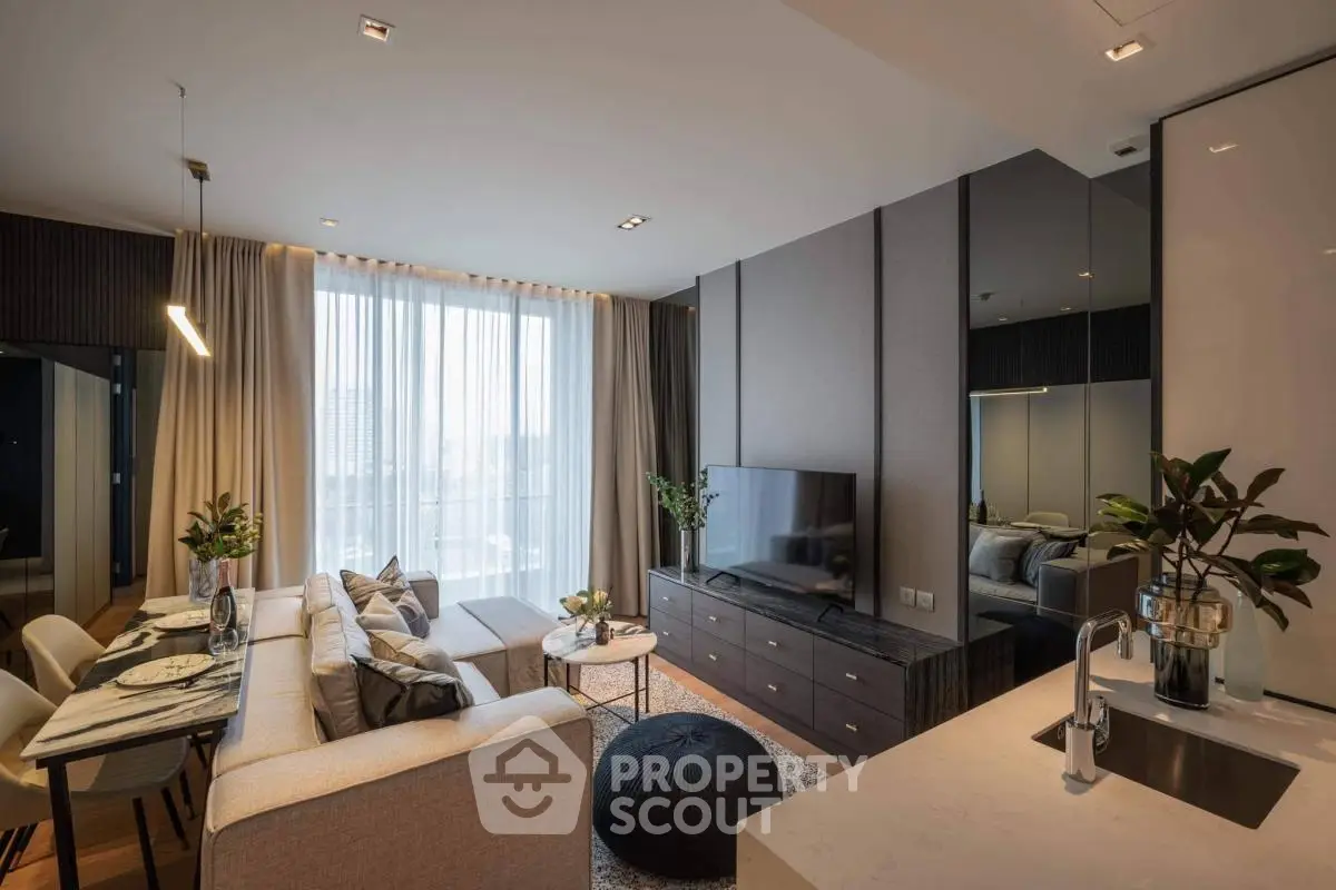 Modern living room with sleek design, large TV, and dining area in a stylish apartment.