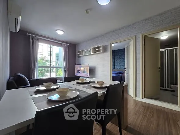 Modern living room with dining area and natural light