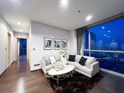 Luxurious living room with stunning city view, elegant decor, and cozy ambiance in modern apartment.