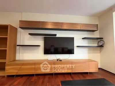 Modern living room with sleek wooden furniture and wall-mounted TV