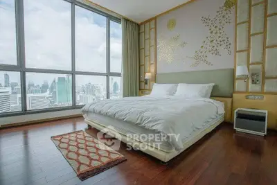 Luxurious bedroom with stunning city view and elegant decor in high-rise apartment.