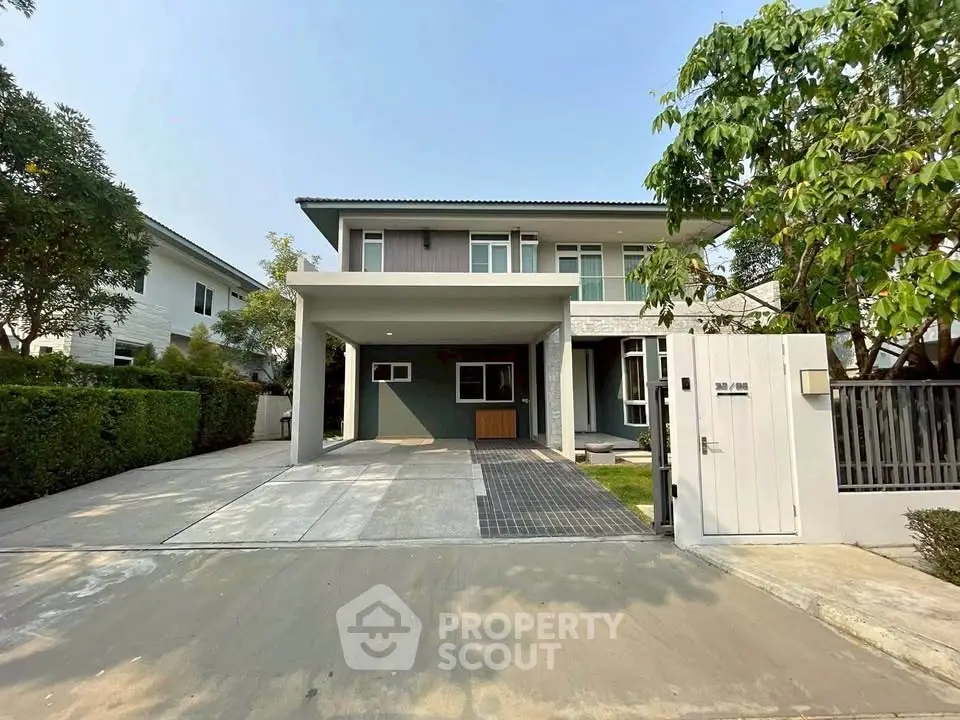 Modern two-story house with spacious driveway and lush greenery in a serene neighborhood.