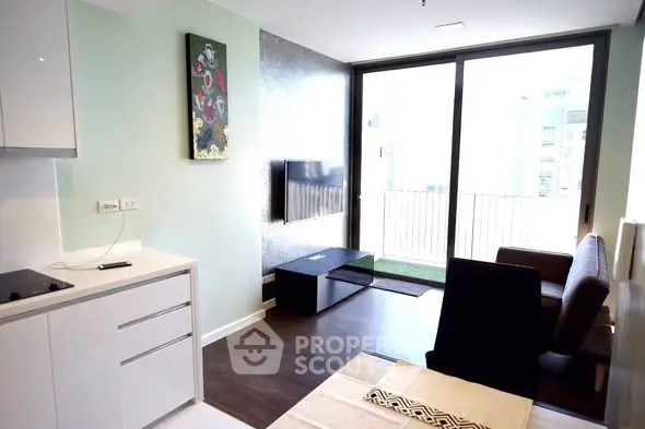 Modern living room with sleek design and large windows opening to a balcony.