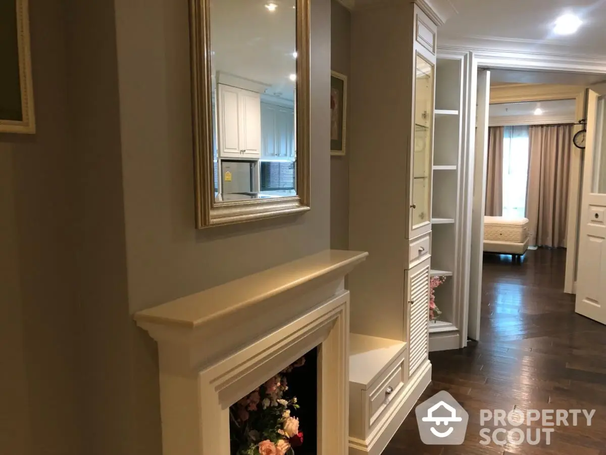 Elegant hallway with hardwood floors and classic decor leading to a cozy bedroom.