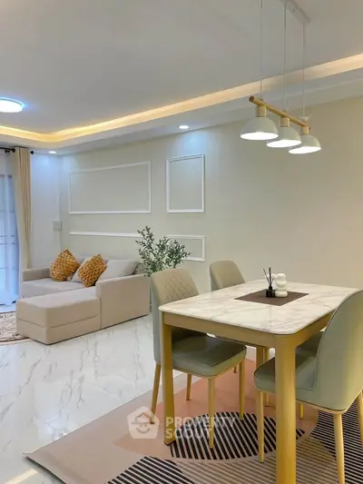 Modern living room with elegant dining area, featuring stylish lighting and cozy seating, perfect for contemporary living.