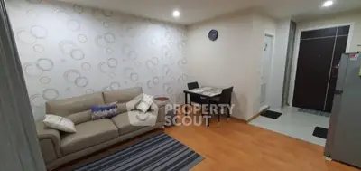 Modern living room with stylish wallpaper and cozy seating area.