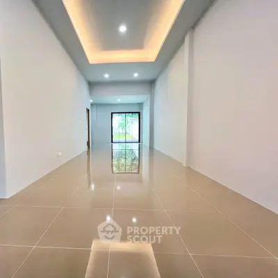 Spacious modern living room with elegant ceiling lights and large windows