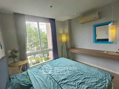 Cozy bedroom with large window and modern decor