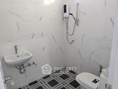 Modern bathroom with sleek fixtures and marble-style tiles