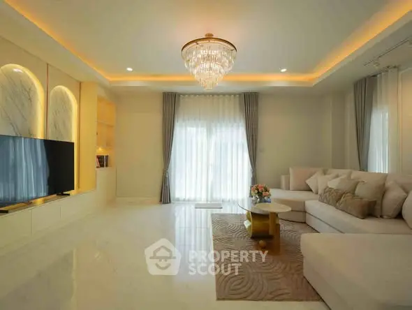 Luxurious living room with elegant chandelier and spacious seating area