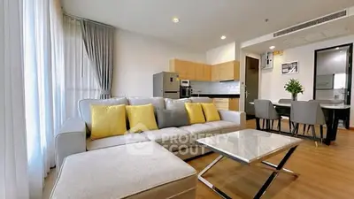 Modern living room with open kitchen and stylish decor