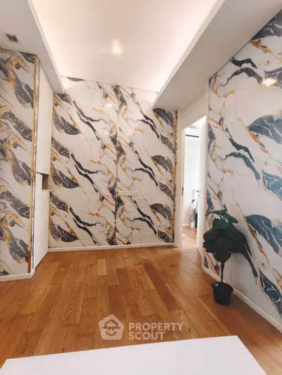 Luxurious interior with marble accent walls and hardwood flooring, perfect for modern living.