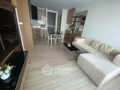 Modern living room with sleek furniture and open kitchen layout