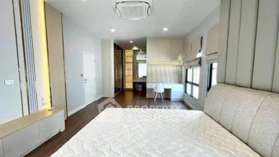 Spacious modern bedroom with elegant design and ample natural light