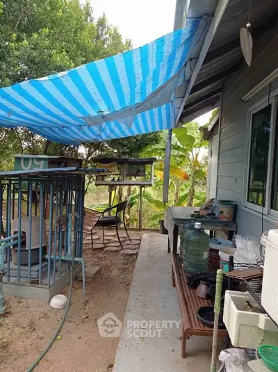 Charming backyard with rustic seating area and lush greenery, perfect for relaxation and outdoor gatherings.