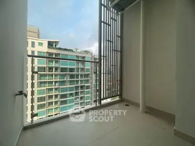 Spacious balcony with city view in modern apartment building