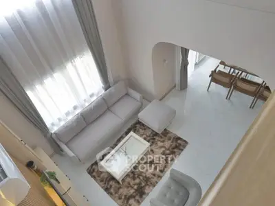 Elegant modern living room with high ceiling and stylish furniture