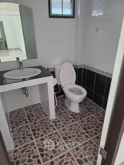 Modern bathroom with stylish tile flooring and sleek fixtures
