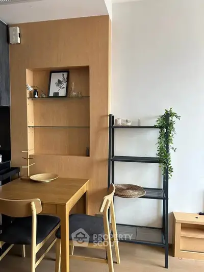 Modern dining area with wooden table and chairs, sleek shelving, and minimalist decor.