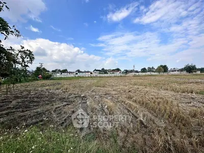 Expansive plot of land with clear skies, ideal for development opportunities.