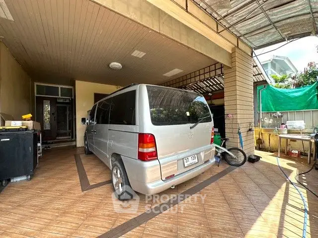 Spacious covered parking area with van and outdoor amenities