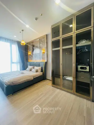 Luxurious bedroom with modern decor and spacious wardrobe in a high-end apartment.