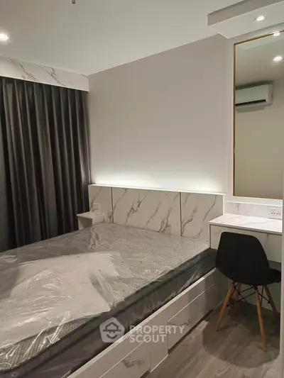 Modern bedroom with stylish decor and built-in storage in a luxury apartment.