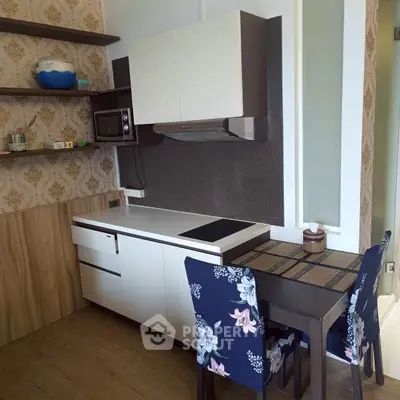 Charming kitchen with modern appliances and cozy dining area, perfect for intimate meals.