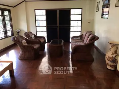 Charming living room with wicker furniture and polished wood flooring