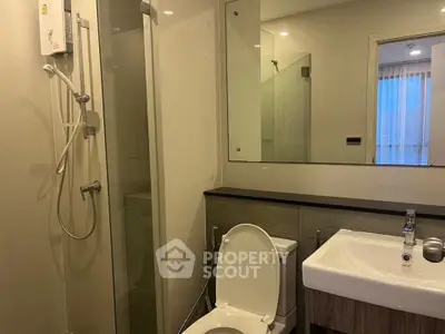 Modern bathroom with glass shower and sleek fixtures