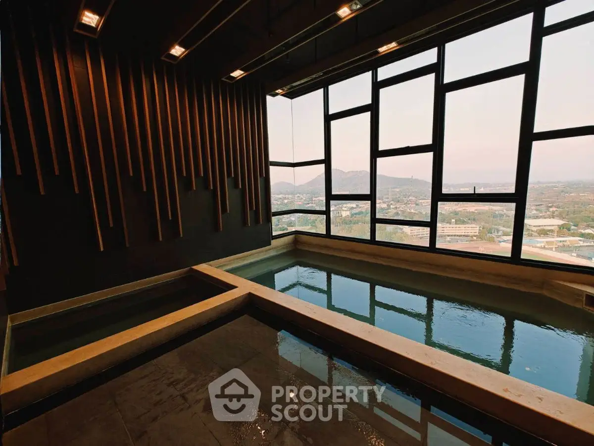 Luxurious indoor pool with panoramic city view and modern design elements.
