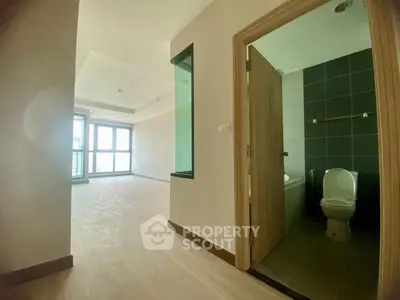 Spacious apartment with modern bathroom and large windows offering natural light.