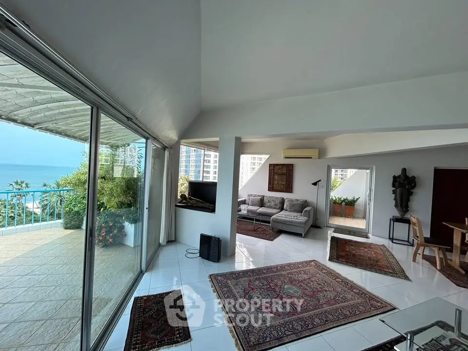 Spacious living room with ocean view and elegant decor in luxury apartment