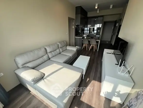 Modern living room with sleek furniture and open kitchen layout