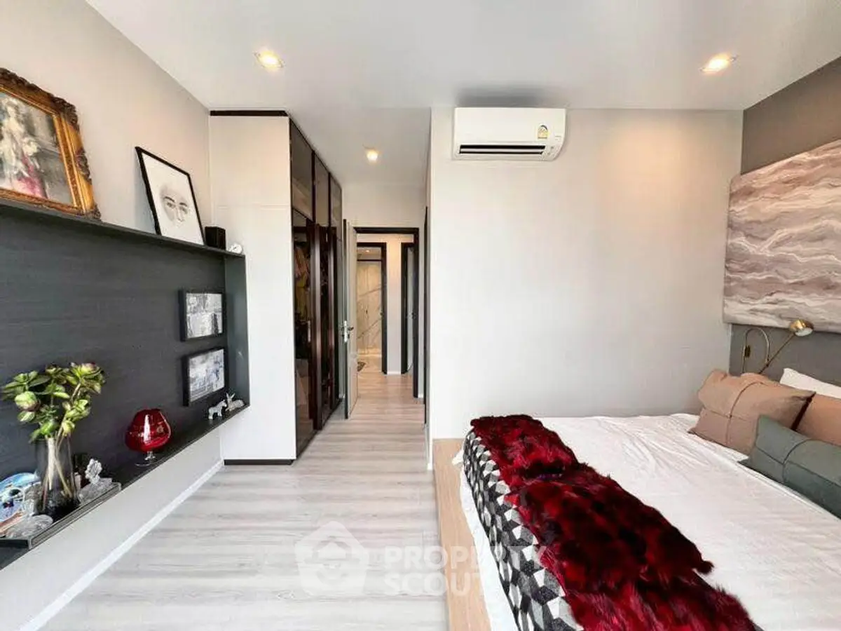 Modern bedroom with stylish decor and ample natural light