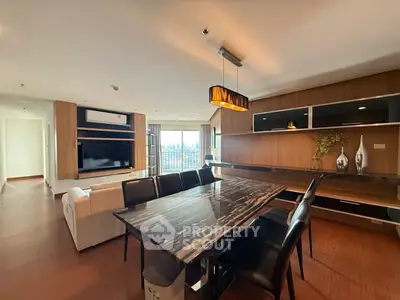 Luxurious open-plan living and dining area with modern decor and city view.