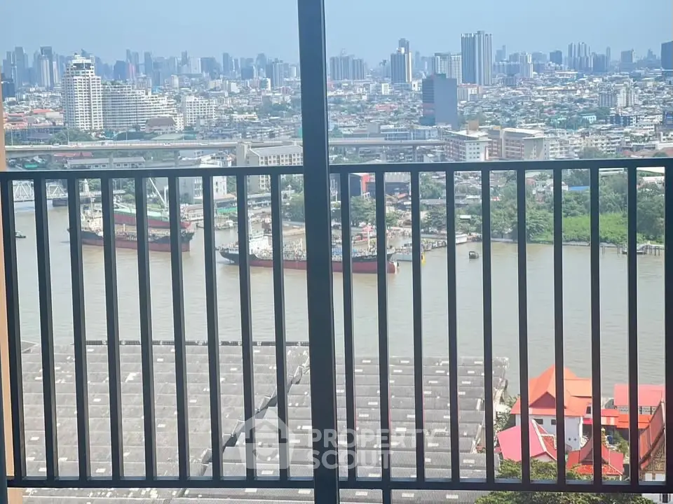 Stunning cityscape and river view from high-rise balcony with modern railing.