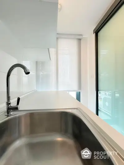 Modern kitchen with sleek stainless steel sink and bright natural lighting