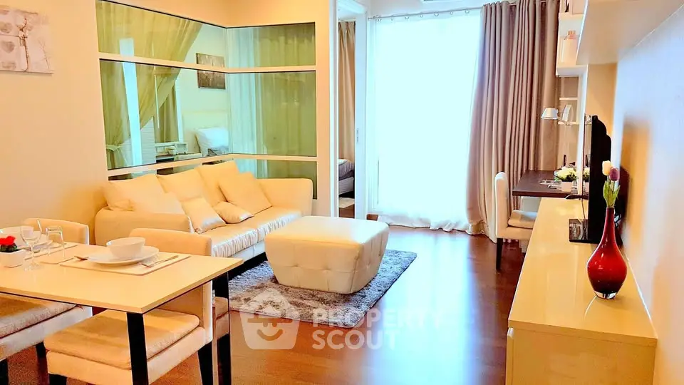 Stylish living room with modern decor and natural light, featuring cozy seating and elegant dining area.