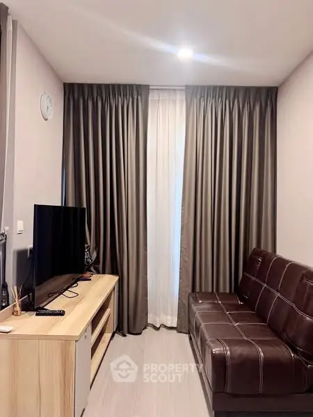 Cozy living room with modern leather sofa and entertainment unit, perfect for relaxation.
