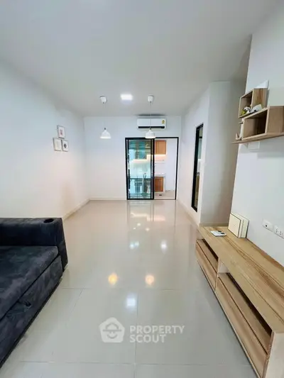 Spacious modern living room with sleek tile flooring and stylish furniture