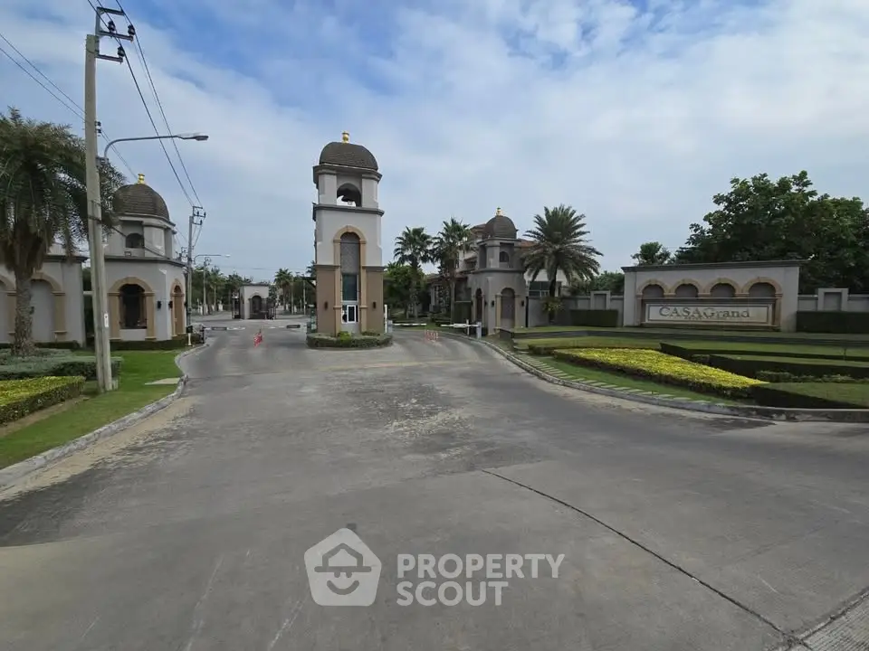 Luxurious gated community entrance with elegant architecture and lush landscaping