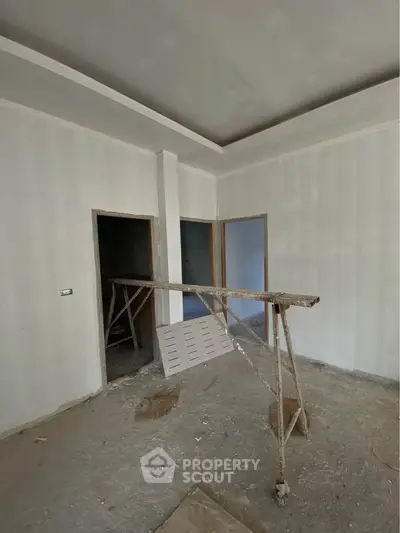 Unfinished interior space with construction materials, potential for customization.