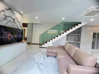 Modern living room with marble flooring and stylish staircase