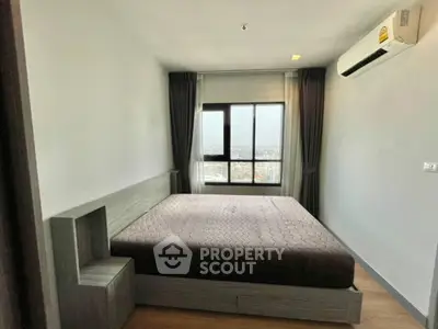 Modern bedroom with large window and air conditioning, offering a cozy and comfortable living space.