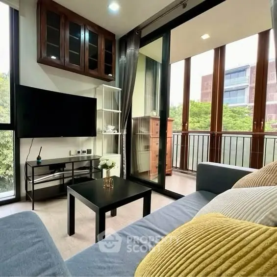 Modern living room with balcony view, stylish decor, and natural light.