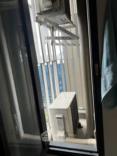 Compact balcony with air conditioning units and city view