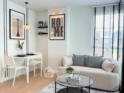 Modern living room with stylish decor, cozy sofa, and dining area in a bright apartment.