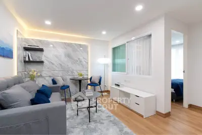 Modern living room with stylish decor and cozy ambiance in a contemporary apartment.