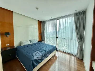 Spacious bedroom with city view and modern design in high-rise apartment